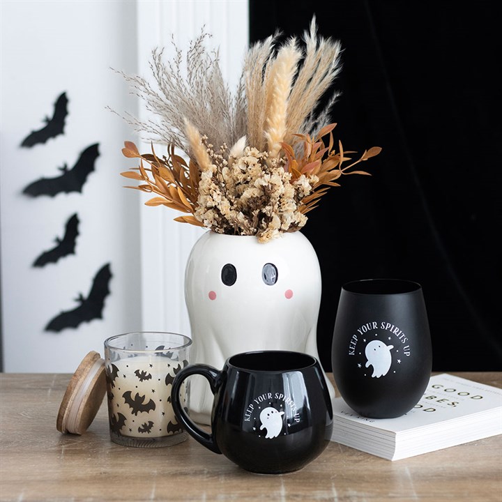 Spooky halloween vases and mugs with bats on the wall